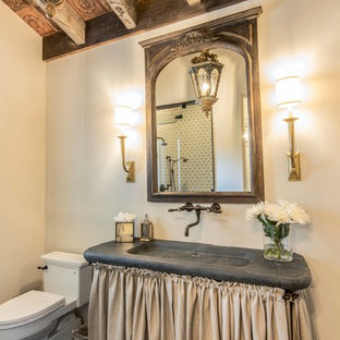 Inspiration for a mid-sized cottage 3/4 multicolored tile and limestone tile black floor and limestone floor alcove shower remodel in Austin with beige walls, an integrated sink, gray countertops, open cabinets, soapstone countertops and a hinged shower door