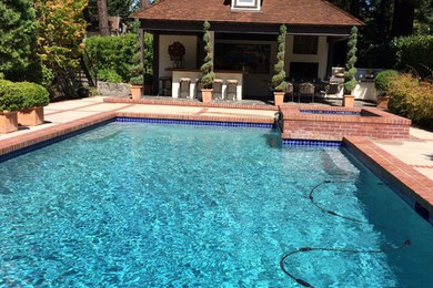 Hot tub - large traditional backyard concrete paver and rectangular hot tub idea in San Francisco
