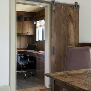 Photo of a rustic home office and library in Boston with white walls.