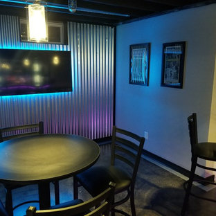 Large industrial walk-out basement with grey walls, concrete flooring and black floors.