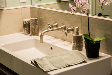 Example of a mid-sized minimalist master beige tile and porcelain tile porcelain tile walk-in shower design in San Francisco with dark wood cabinets, a one-piece toilet and green walls