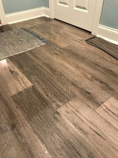 Vinyl plank flooring is coming up in newly created basement