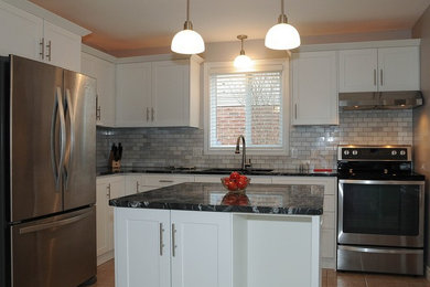Example of a transitional kitchen design in Calgary