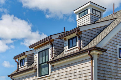Example of a beach style home design design in Boston