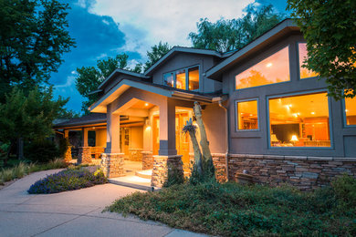 Inspiration for a large beige two-story stucco exterior home remodel in Denver