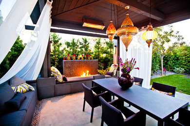 Inspiration for a huge backyard concrete patio remodel in San Diego with a fire pit and a gazebo