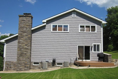 Gray two-story wood exterior home photo in New York