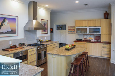 Inspiration for a large contemporary u-shaped porcelain tile open concept kitchen remodel in Jacksonville with a double-bowl sink, flat-panel cabinets, light wood cabinets, quartz countertops, beige backsplash, ceramic backsplash, stainless steel appliances and an island
