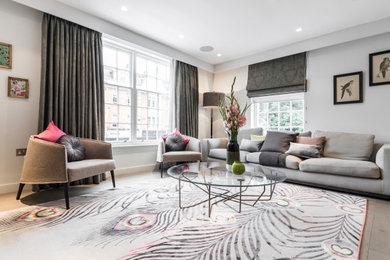 Medium sized modern living room curtain in London with grey walls, light hardwood flooring and brown floors.