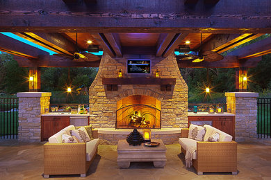 Mid-sized transitional backyard stone patio kitchen photo in Minneapolis with a gazebo