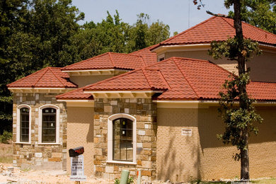 Photo of a large traditional two-storey brown house exterior in Dallas with mixed siding, a gable roof and a tile roof.