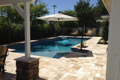 Pool house - mid-sized backyard brick and rectangular pool house idea in Phoenix