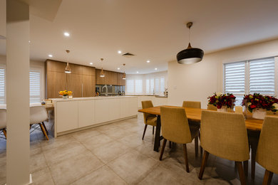 Inspiration for a large contemporary u-shaped open plan kitchen in Sydney with flat-panel cabinets and multiple islands.