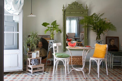 Photo of a mid-sized mediterranean dining room in Madrid with white walls, ceramic floors and no fireplace.