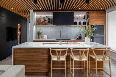 Example of a huge trendy single-wall light wood floor and beige floor eat-in kitchen design in Vancouver with an undermount sink, flat-panel cabinets, medium tone wood cabinets, quartz countertops, white backsplash, paneled appliances, an island, white countertops and mosaic tile backsplash