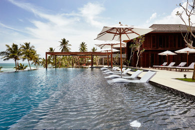 Island style pool photo in Other