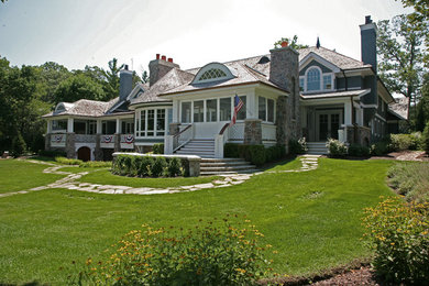 Large traditional white two-story mixed siding house exterior idea in Milwaukee with a hip roof and a shingle roof
