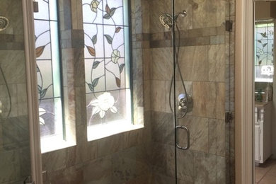 This is an example of a mid-sized transitional master bathroom in Dallas with a curbless shower, multi-coloured tile, ceramic tile, ceramic floors, beige floor and a hinged shower door.
