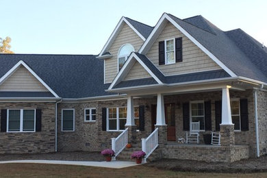 Design ideas for a large traditional two-storey beige house exterior in Other with mixed siding, a gable roof and a shingle roof.