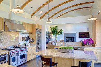 This is an example of a large transitional l-shaped eat-in kitchen in San Francisco with a double-bowl sink, recessed-panel cabinets, light wood cabinets, granite benchtops, beige splashback, stainless steel appliances, ceramic floors and with island.