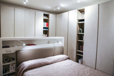 Photo of a contemporary bedroom in Rome with light hardwood flooring.