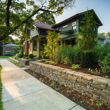 Dry-stacked fieldstone wall along the sidewalk