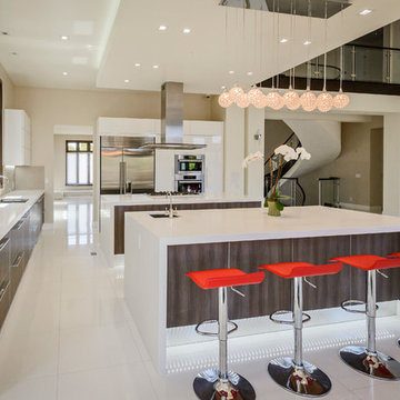 Two islands with prep sink and breakfast bar