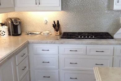 Mid-sized transitional l-shaped travertine floor and brown floor eat-in kitchen photo in Orange County with shaker cabinets, white cabinets, marble countertops, beige backsplash, mosaic tile backsplash, stainless steel appliances and an island