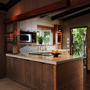 Design ideas for a mid-sized tropical u-shaped kitchen pantry in Hawaii with flat-panel cabinets, quartzite benchtops, green splashback, mosaic tile splashback, an undermount sink, medium wood cabinets and stainless steel appliances.