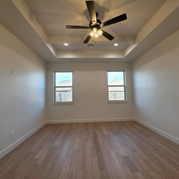 Primary/Master Bedroom feature beamed trey ceilings
