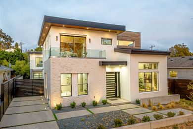 Inspiration for a contemporary multicolored two-story exterior home remodel in Orange County with a brown roof