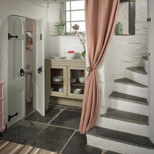 Inspiration for a small shabby-chic style concrete curved staircase in Cornwall with concrete risers.