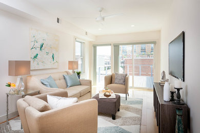 Example of a living room design in DC Metro with a wall-mounted tv