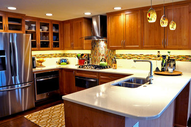 Mid-sized minimalist u-shaped medium tone wood floor and brown floor kitchen photo in Seattle with a double-bowl sink, shaker cabinets, medium tone wood cabinets, quartz countertops, multicolored backsplash, matchstick tile backsplash, stainless steel appliances and a peninsula