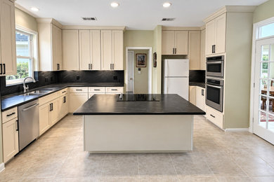 Inspiration for a large transitional kitchen remodel in Houston with a double-bowl sink, shaker cabinets, beige cabinets, quartz countertops, black backsplash, quartz backsplash, an island and black countertops