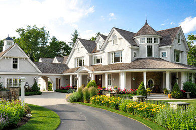 Example of a large classic gray three-story mixed siding house exterior design in Boston with a clipped gable roof and a shingle roof