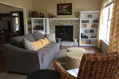 Inspiration for a large transitional open concept medium tone wood floor family room remodel in DC Metro with yellow walls, a standard fireplace, a stone fireplace and no tv