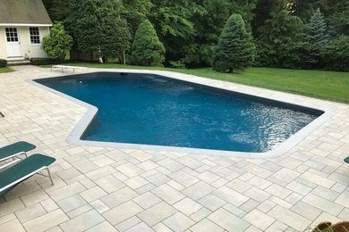 Example of a trendy backyard pool design in New York