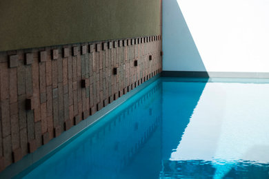 Design ideas for a contemporary pool in Perth with brick pavers.