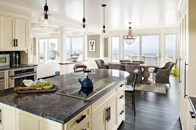 Design ideas for an expansive beach style u-shaped eat-in kitchen in Boston with a farmhouse sink, shaker cabinets, white cabinets, granite benchtops, blue splashback, stone slab splashback, stainless steel appliances, dark hardwood floors, with island and brown floor.