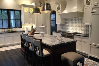 Mid-sized transitional l-shaped dark wood floor eat-in kitchen photo in San Francisco with an undermount sink, shaker cabinets, white cabinets, marble countertops, multicolored backsplash, porcelain backsplash, stainless steel appliances and an island