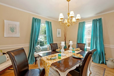 Mid-sized elegant light wood floor enclosed dining room photo in New York with beige walls