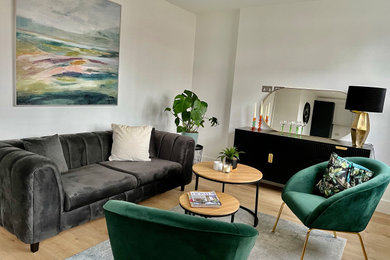 Inspiration for a medium sized contemporary living room in London with white walls and light hardwood flooring.