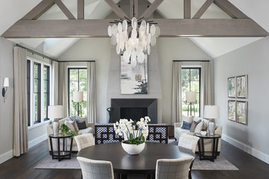 Kitchen/dining room combo - transitional dark wood floor, brown floor and vaulted ceiling kitchen/dining room combo idea in Grand Rapids with a standard fireplace and gray walls