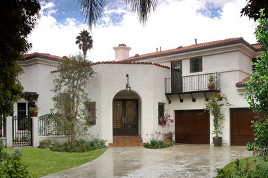 Large mediterranean white two-story stucco exterior home idea in Los Angeles