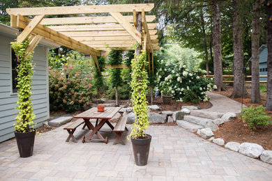 Patio - mid-sized rustic backyard concrete paver patio idea in New York