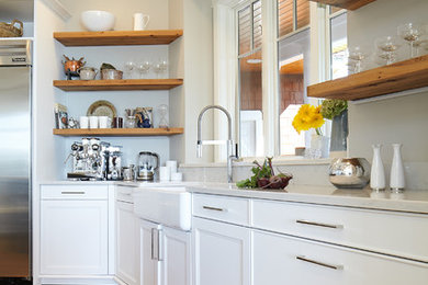 Large transitional u-shaped light wood floor and beige floor eat-in kitchen photo in Seattle with a farmhouse sink, white cabinets, stainless steel appliances, an island, white countertops, recessed-panel cabinets and solid surface countertops