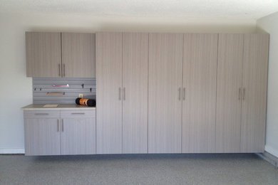 Large trendy attached two-car garage photo in Other