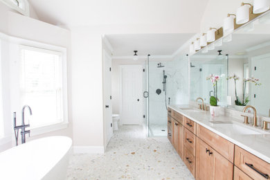 Large elegant master terrazzo floor and double-sink bathroom photo in Atlanta with light wood cabinets, white walls, an undermount sink, quartzite countertops, a hinged shower door, beige countertops, a niche and a built-in vanity