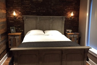 Bedroom - rustic master medium tone wood floor bedroom idea in New York